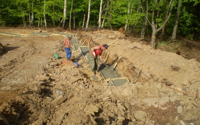 Opěrná zeď vyrovnávající strmý terén stanice lanové dráhy sjezdovky v Klínech