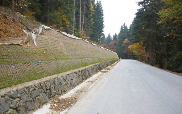 Výškové oddělení silnice a cyklostezky strmým svahem v Prášilech na Šumavě